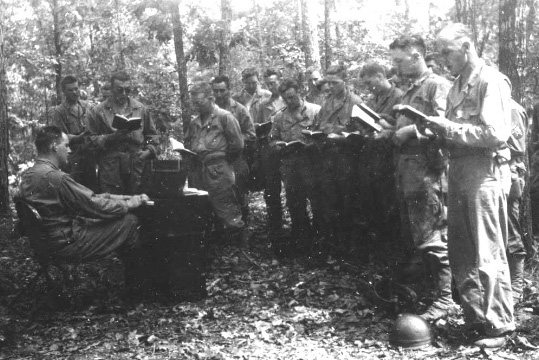 499. C Battery 492nd AFA having church in the field with Cha